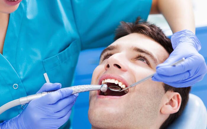 A dentist examining a patient's teeth.