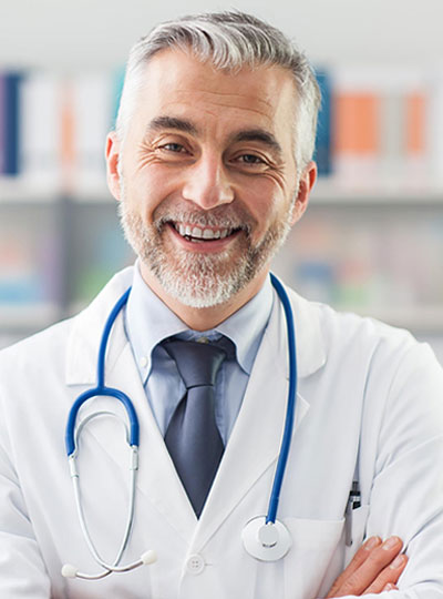 Smiling doctor wearing a white coat.