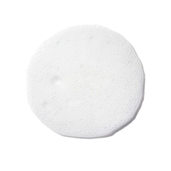 A white round pad is sitting on the floor.