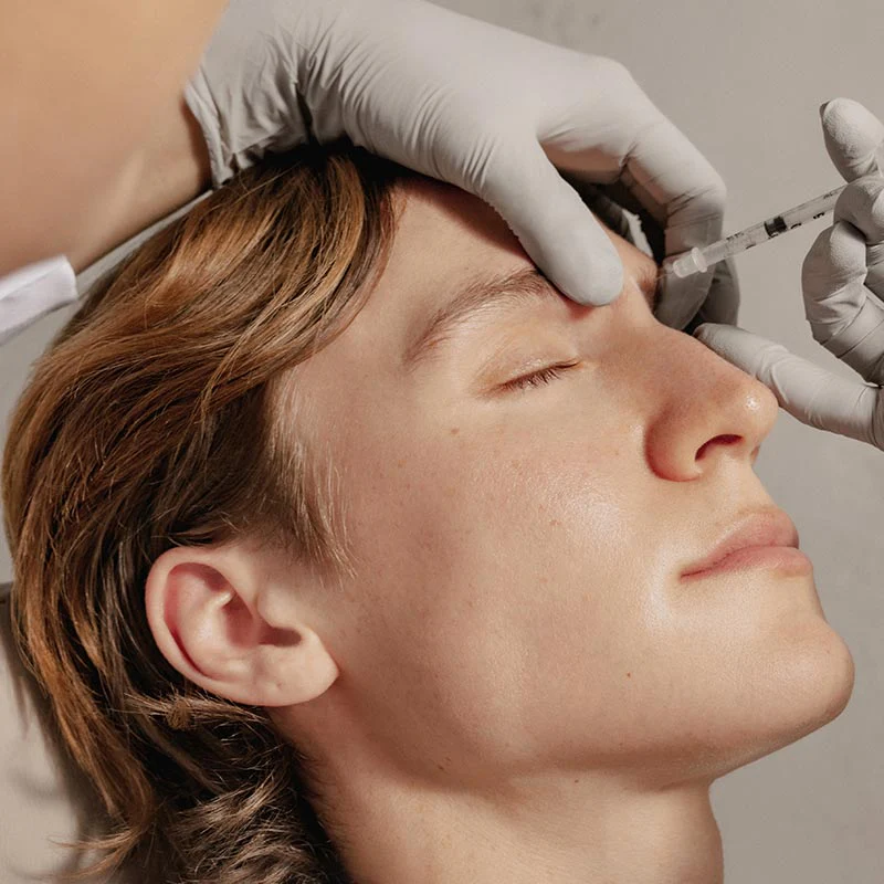 Man receiving a facial injection.