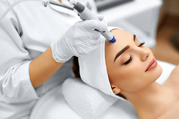 Woman receiving facial treatment at spa.