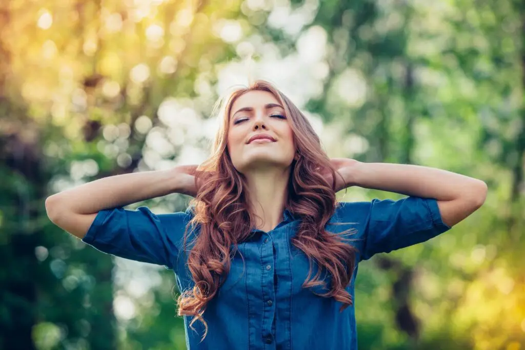 Woman with long hair relaxing outdoors.